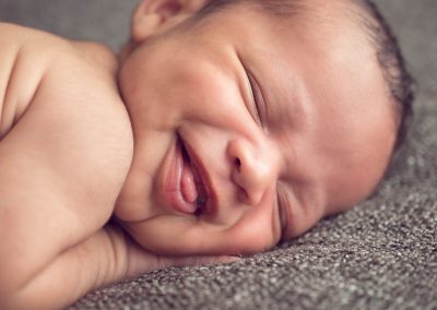 Newborn boy smiling | newborn photography san diego | Visit www.babiesandbeauties.com