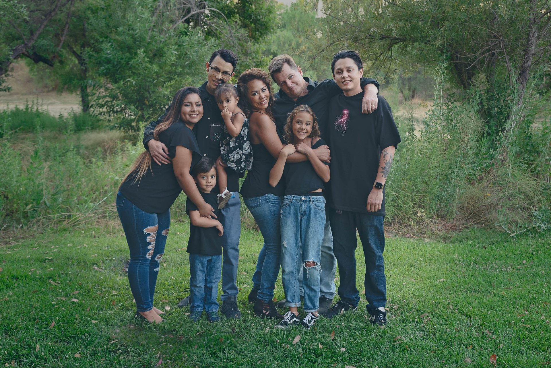 Extended family wearing jeans and black tops in park | Family photography san diego | Visit www.babiesandbeauties.com