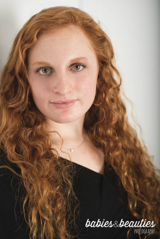 Headshot of young lady with red hair in a black top | headshots san diego | www.babiesandbeauties.com