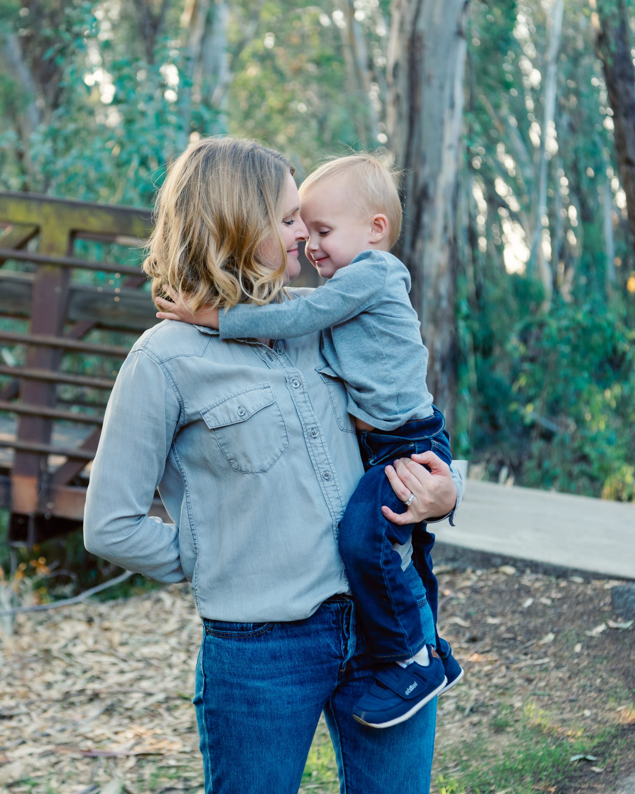 Mother holding 2 year old son in front of trees. family photography san diego | Visit www.babiesandbeauties.com