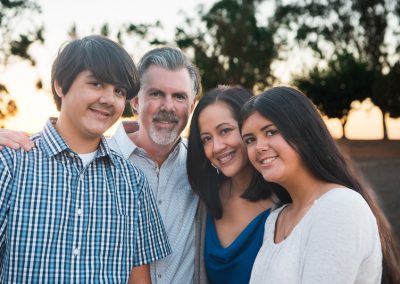 Family of four leaning together at sunset | family photography san diego | Visit www.babiesandbeauties.com