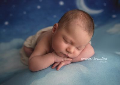 Newborn baby on cloud and moon backdrop | newborn photography in san diego | Visit www.babiesandbeauties.com to learn more!