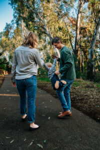 Family photo captures parents showing their toddler what it's like to fly like superman